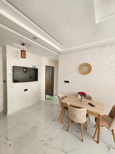 a dining room with a table and chairs at New 3 bedrooms apartment steps away from bus station in Tangier