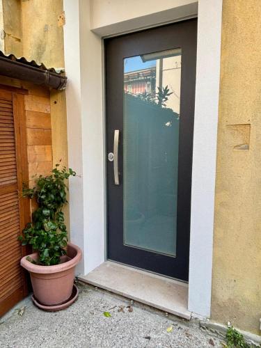 a black door with a potted plant in front of a house at Villa Vittoria Apartments in Venice-Lido