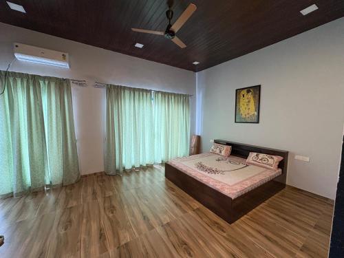 a bedroom with a bed and a ceiling fan at Aweka Villa - 3 BHK Riverside - Karjat in Dhamni