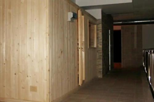an empty hallway with wood paneling in a building at Costa SPA Superior de lujo - Playa de las Catedrales in San Miguel de Reinante