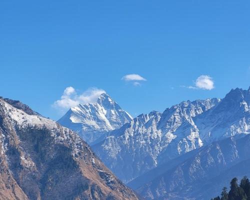 a view of a mountain range with snow covered mountains at Mount Valley Martolia Resort in Joshīmath