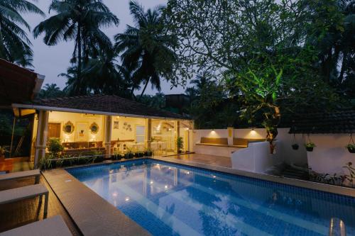 a swimming pool in front of a house at Pvt Pool - Villa Azura Escape - Casa Marialina 8 BR in Saligao