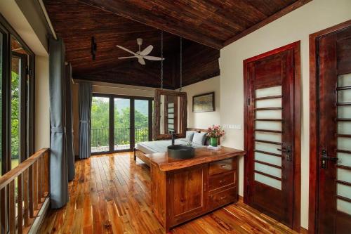 a living room with a ceiling fan and wooden floors at Scent Home in Sóc Sơn