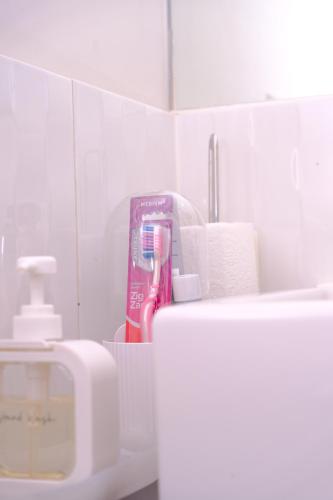 a bathroom with a toothbrush and a box of toothpaste at Homely Retreat-4 Minutes from Pacific Werribee Shopping Centre in Werribee