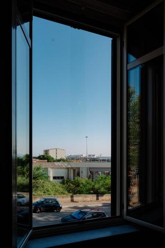 a window with a view of a parking lot at Calabreeze in Villa San Giovanni