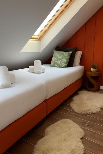 a bedroom with a bed with a skylight at the Herbalist in Tihany