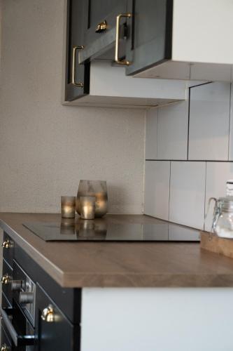 a kitchen with a counter with candles on it at Cozy white house close to the nature with Wi-Fi 