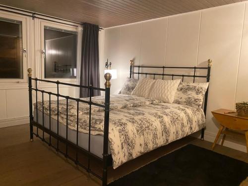 a bedroom with a bed and a table and a window at Cozy white house close to the nature with Wi-Fi 