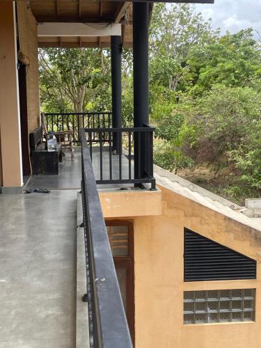 a balcony of a house with a railing at Nature's Hideaway in Anuradhapura