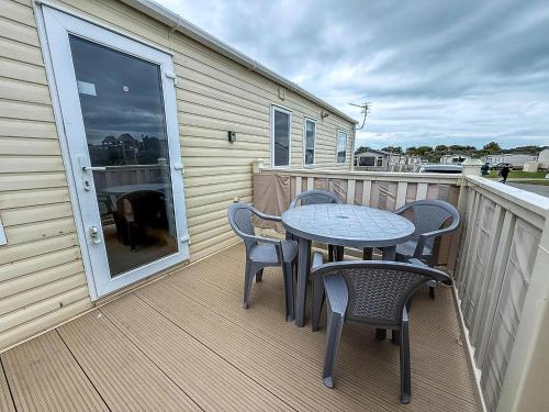 a patio with a table and chairs on a balcony at Brilliant 6 Berth Caravan For Hire At Sunnydale Park In Skegness Ref 35076Af in Louth