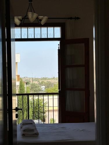 a room with a bed and a window with a view at Villa Saint George - Stone Costa in Kathikas