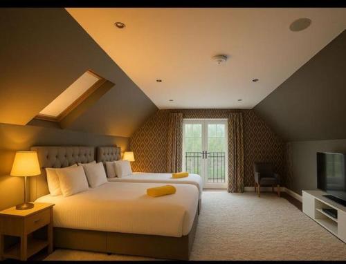 a bedroom with a large bed and a television at Brig O'Doon 1 in Ayr