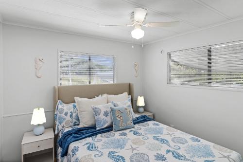 a bedroom with a bed and a ceiling fan at Saltys Retreat with a 50 Ft Dock at Crystal River in Crystal River