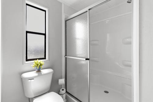 a bathroom with a toilet and a glass shower at Saltys Retreat with a 50 Ft Dock at Crystal River in Crystal River