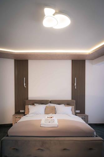 a bedroom with a large bed with a ceiling at Royal View Guest House in Dospat