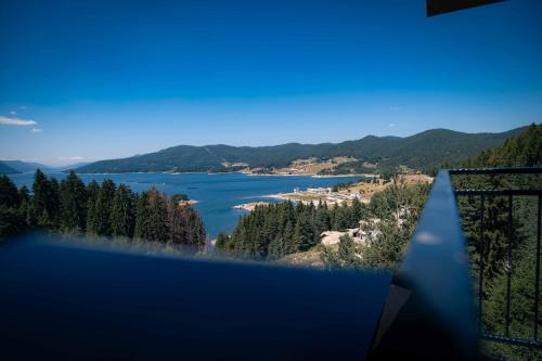 a view of a lake from a balcony at Royal View Guest House in Dospat