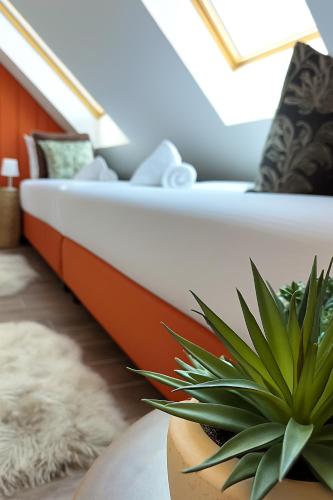 a living room with a couch and a plant at the Herbalist in Tihany