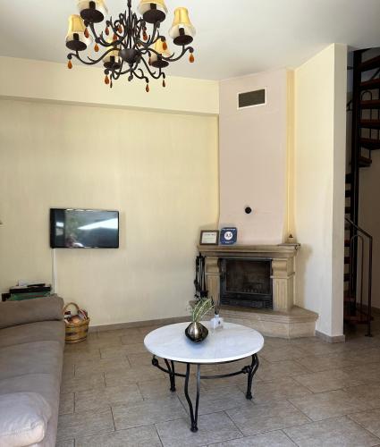a living room with a couch and a table at Villa Saint George - Stone Costa in Kathikas