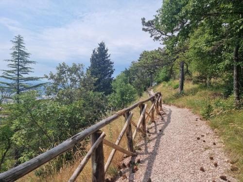a path on a hill with a wooden fence at BnB Bagno di Bosco in Gubbio