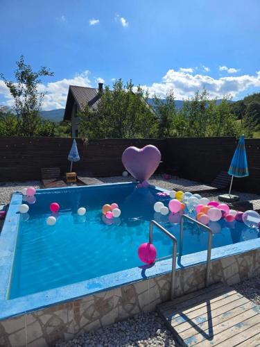 a swimming pool with a heart and balloons in it at VIKENDICA NOLE Jahorina in Pale