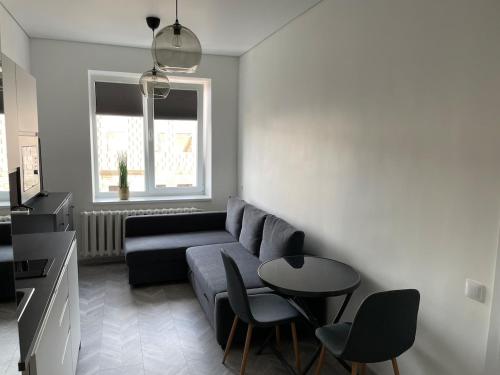 a living room with a couch and a table at Suite in the heart of the city in Panevėžys