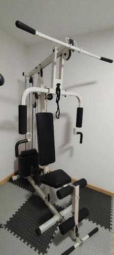 a room with a gym with a chair and a treadmill at Chalupa u Kahounů in Popovice