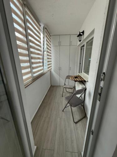 a room with a table and chairs and a window at House in Cisnădie