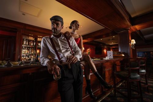 a man and a woman standing in a bar at Jolie Ville Hotel & Spa Kings Island Luxor in Luxor