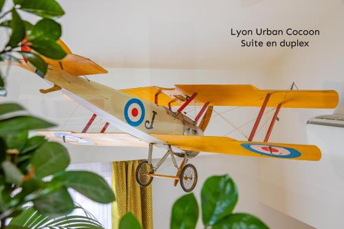 a small toy airplane hanging from a wall at Lyon Urban Cocoon Gîte urbain eco-responsable in Lyon