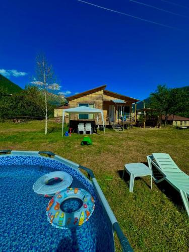 a backyard with a table and a bench and a house at HOMELAND in Mestia