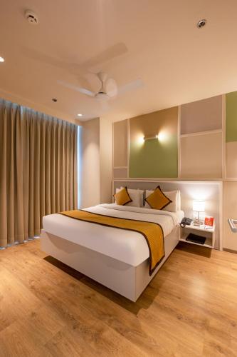 a bedroom with a large bed and a window at The Trot Hotel & Suites near Yashobhoomi Udyog vihar in Gurgaon