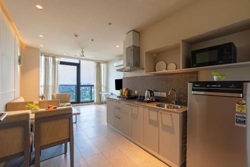 a kitchen with a sink and a counter top at The Trot Hotel & Suites near Yashobhoomi Udyog vihar in Gurgaon