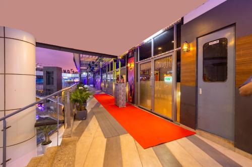 a balcony of a building with a red carpet at The Trot Hotel & Suites near Yashobhoomi Udyog vihar in Gurgaon