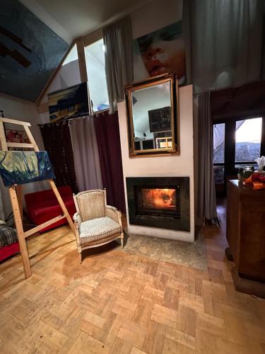 a living room with a fireplace and a mirror at Villatopol in Rząska