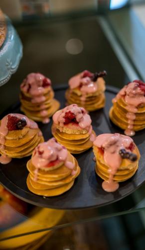 a bunch of pancakes with pink frosting on a plate at Doors Boutique Hotel in Tbilisi City