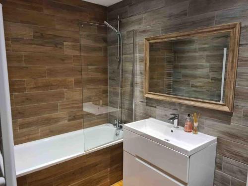 a bathroom with a tub and a sink and a shower at Cosy 2 Bedroom Coastal Retreat with Sea Views and a Private Indoor Hot Tub in Margate
