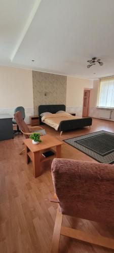 a living room with a bed and a table at Iranija 21 in Daugavpils