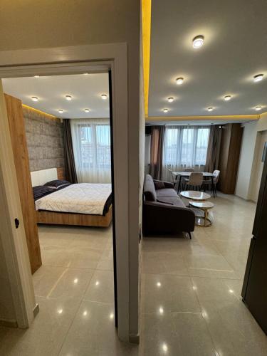 a bedroom and a living room with a bed and a couch at New apartment in centre Yerevan in Yerevan