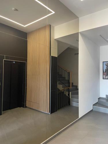 a room with a staircase and a wooden wall at Citysmart Apartment in Tuzla