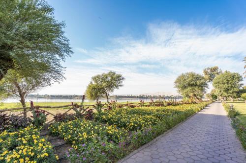a walkway in a park with flowers at Jolie Ville Hotel & Spa Kings Island Luxor in Luxor