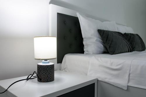 a bedroom with a bed and a lamp on a desk at Hotel Palas Grand View in Iaşi