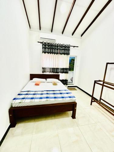 a bedroom with a bed in a room at Dinsara Villa Mirissa,Kamburugamuwa in Kamburugamuwa