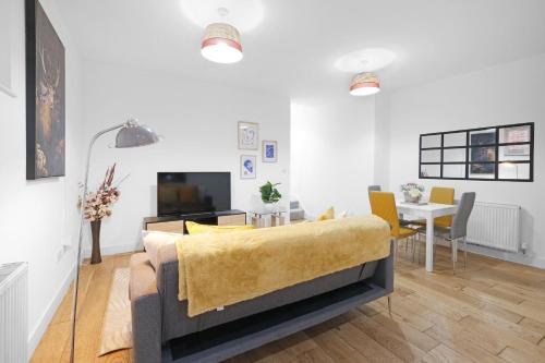 a living room with a bed and a dining room at Eastons 1 Bedroom Apartment with Sofa Bed in High Wycombe