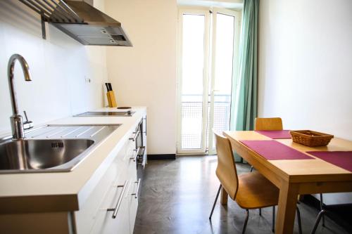- une cuisine avec un évier et une table en bois dans l'établissement Residence Igea, à Rimini