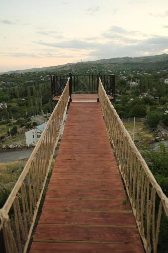 a wooden bridge with a view of a city at IN CLOUDS RESORT Byurakan in Antarut