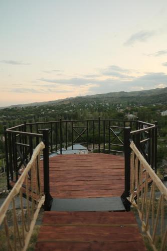 a wooden bridge over a body of water with a view at IN CLOUDS RESORT Byurakan in Antarut