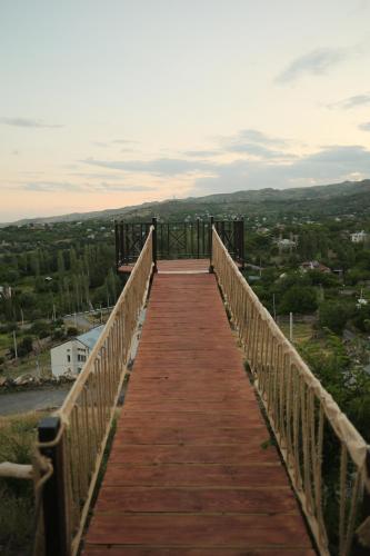 a wooden bridge with a view of a city at IN CLOUDS RESORT Byurakan in Antarut