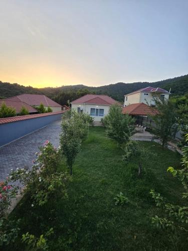 a view of a yard with houses and a driveway at Julian Guest House in Cülyan