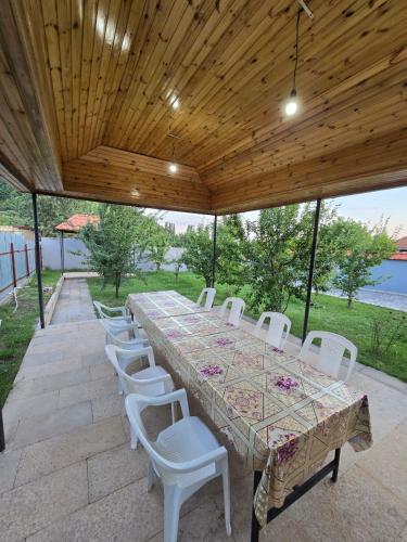 a large table and chairs on a patio at Julian Guest House in Cülyan