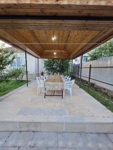 a patio with a table and chairs under a pavilion at Julian Guest House in Cülyan